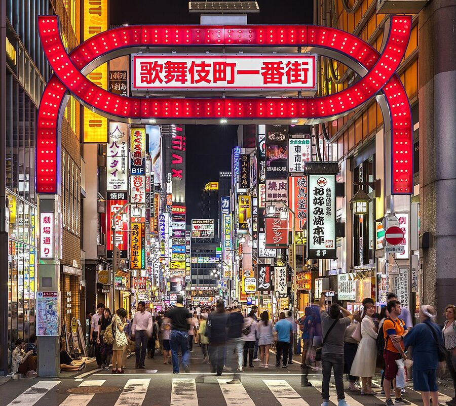 Kabukicho red gate at night with neon signs and crowds