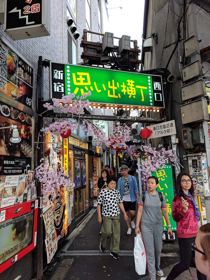 Entrance to Omoide Yokocho with red lanterns and signage