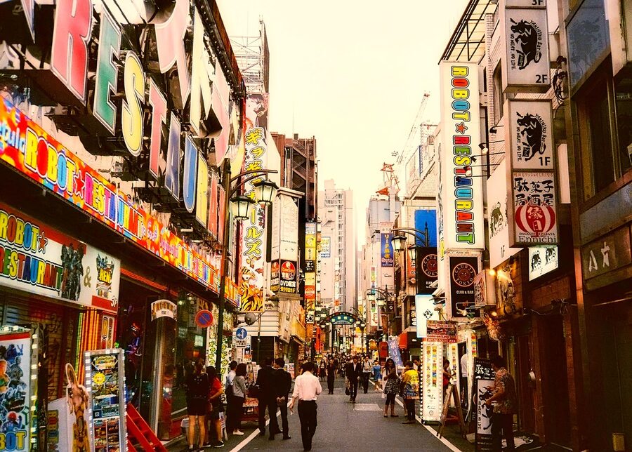 Narrow Shinjuku alley with bar signs at night