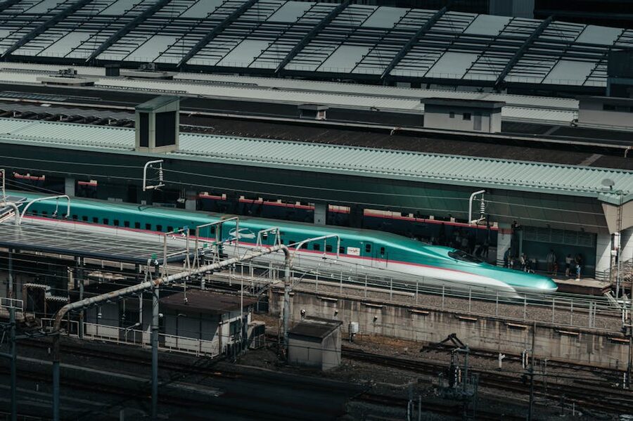Modern shinkansen at Tokyo Station with passengers
