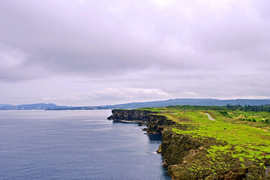 Okinawa coastal cliffs with green hills