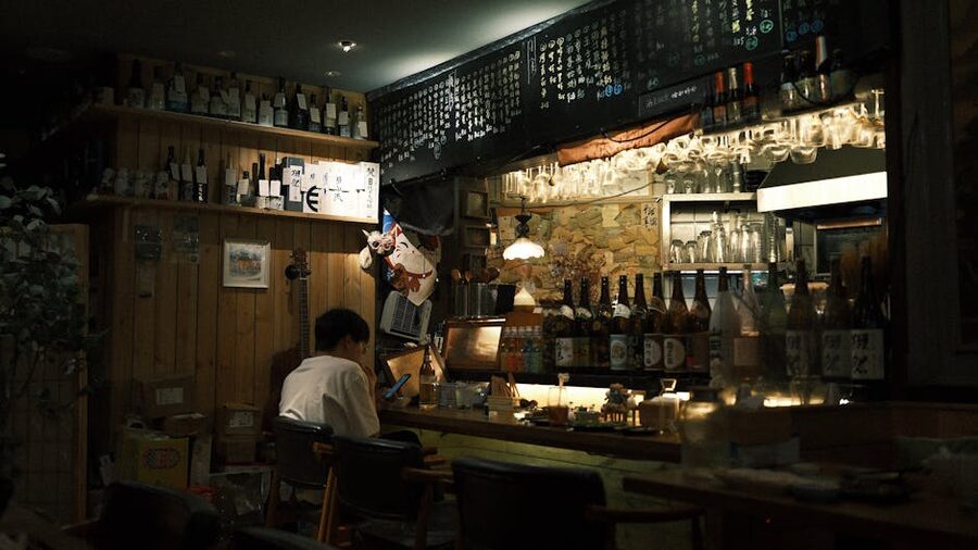 Cozy Japanese bar interior with dim warm lighting