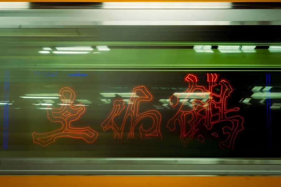 Tokyo train moving at night with neon lights