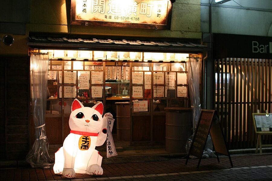 Maneki neko cat figure outside a tachinomi standing bar in Kajicho Tokyo