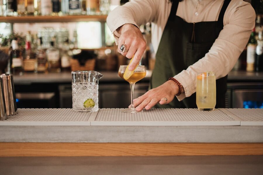 Bartender garnishing cocktail at an upscale Tokyo bar counter