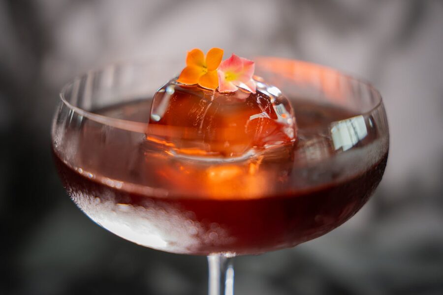 Cocktail with floral garnish in coupe glass