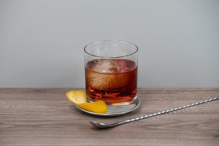 Whiskey old fashioned with ice sphere and citrus peel