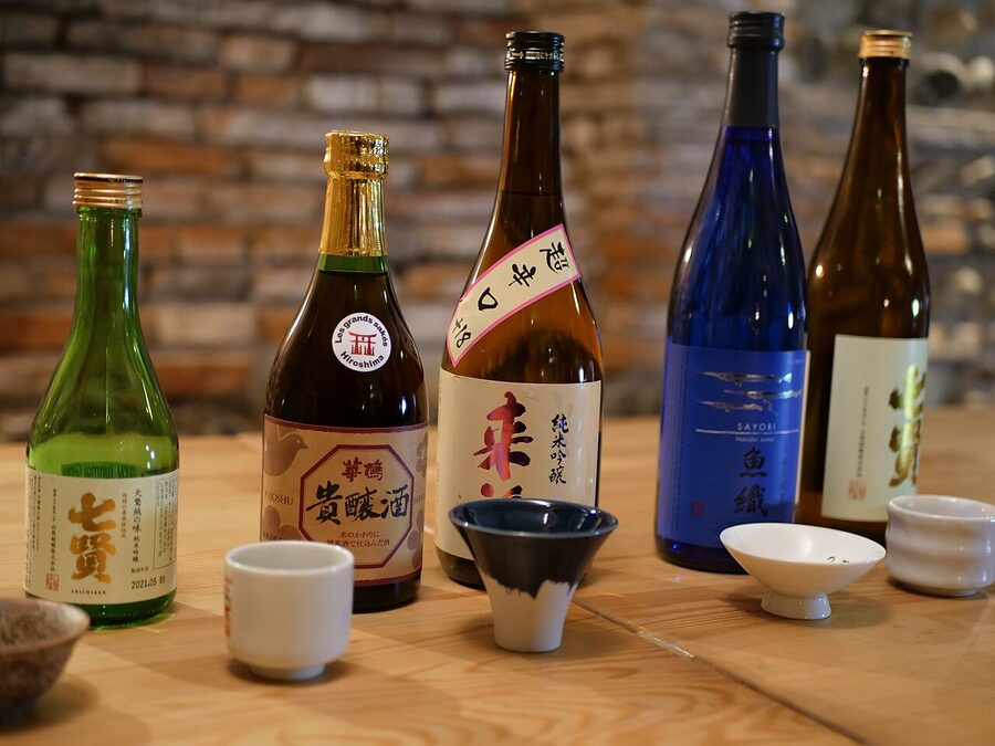 Japanese sake bottles and glasses on a counter