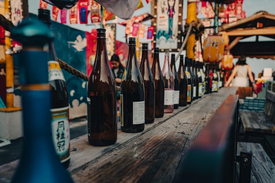 Row of sake bottles lined up at a tasting bar