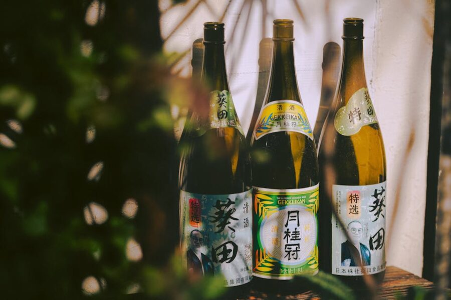 Three Japanese sake bottles in natural light
