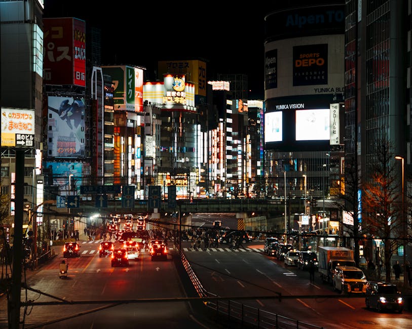 Shinjuku Tokyo street at night with dense neon signage and pedestrians