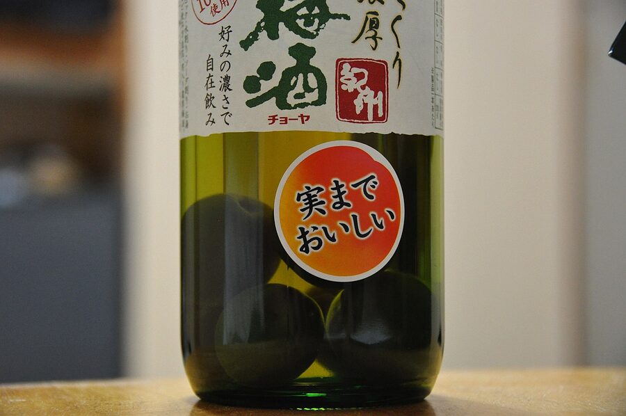 Umeshu bottle and a glass on a table